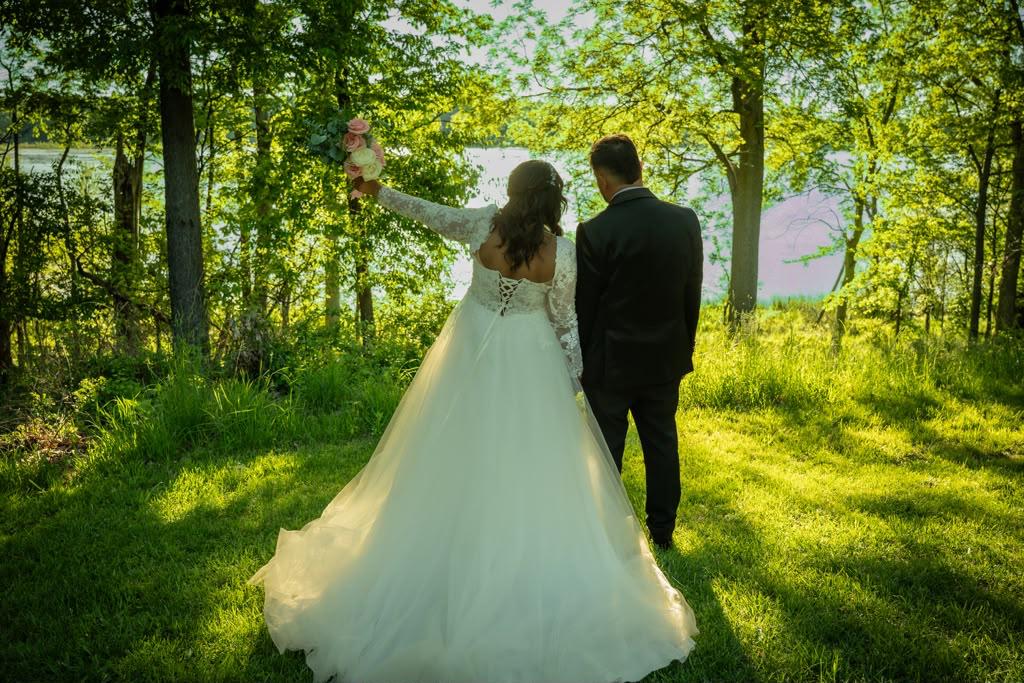 Real wedding — couple by the lake surrounded by trees